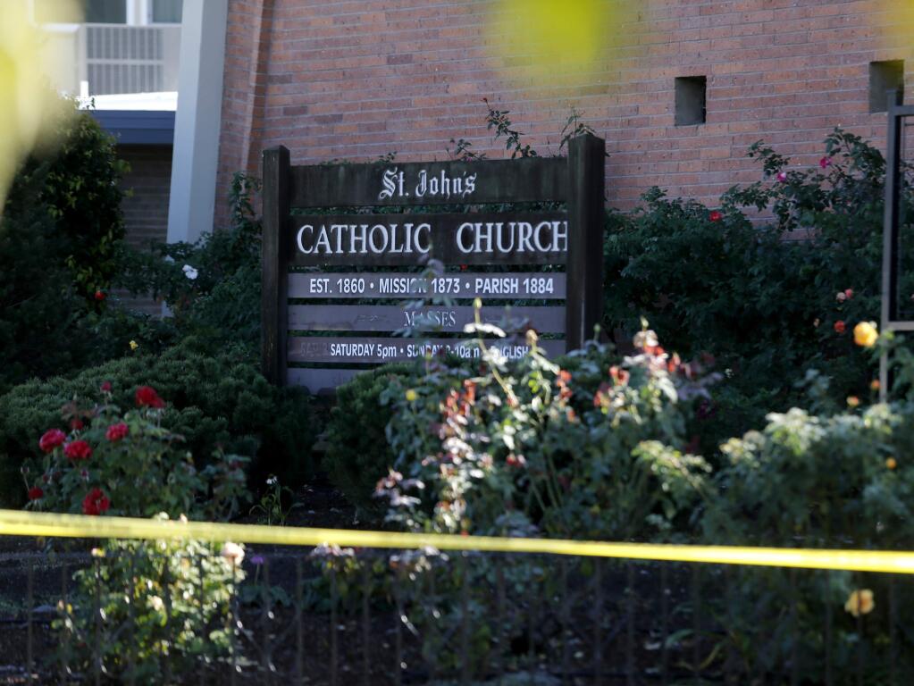 Police tape cordons off the area around St. John's Catholic Church on Monday, Nov. 21, 2016 in Healdsburg, California. (The Press Democrat)