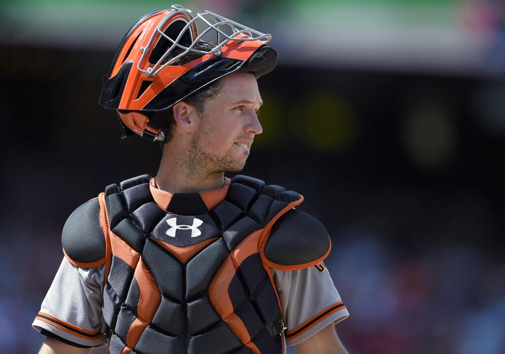 FILE - In this Aug. 7, 2016, file photo, San Francisco Giants catcher Buster Posey looks toward the infield during the team's baseball game against the Washington Nationals in Washington. Posey won a Gold Glove award for fielding excellence, announced Tuesday, Nov. 8, by Rawlings. (AP Photo/Nick Wass, File)
