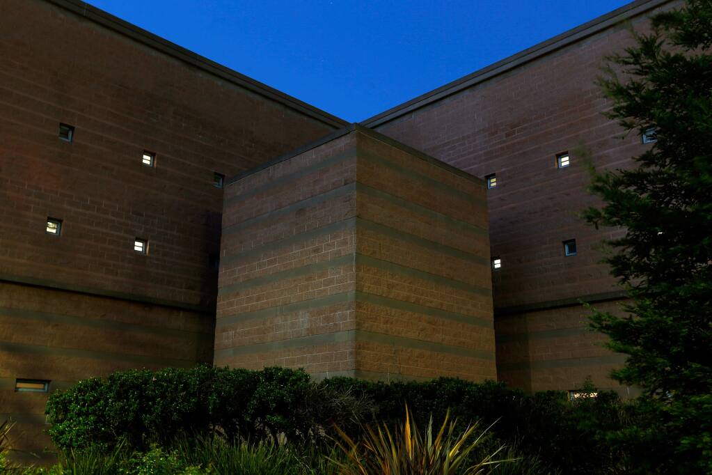 Interior lights shine through small exterior windows at the Sonoma County Sheriff's Office Main Adult Detention Facility in Santa Rosa, California, on Thursday, March 30, 2017. (ALVIN JORNADA/ PD)