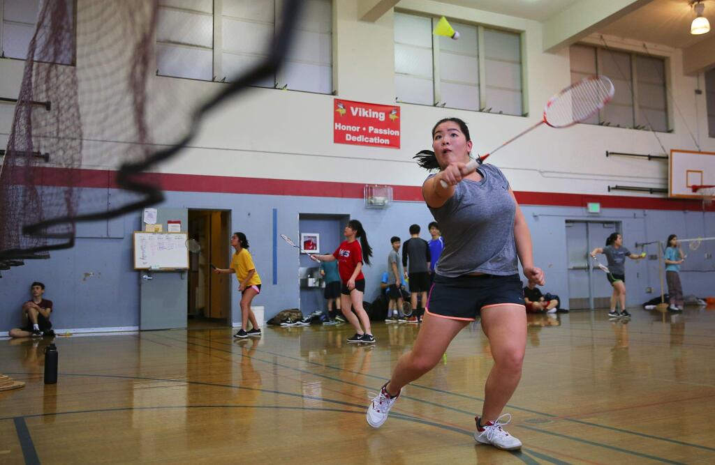 Karen Cai hits a return during badminton practice at Montgomery High School in Santa Rosa on Monday, April 17, 2017. (Christopher Chung/ The Press Democrat)