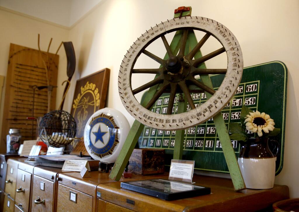 -Clockwise from left, the typewriter used by ranch manager Fred Keppel on the old Cotati Ranch, an accordion belonging to Jim Boggio, who co-created the Cotati Accordion Festival, and an antique wheel of fortune game used by the Odd Fellows for fundraisers, all on display at the Cotati Museum.