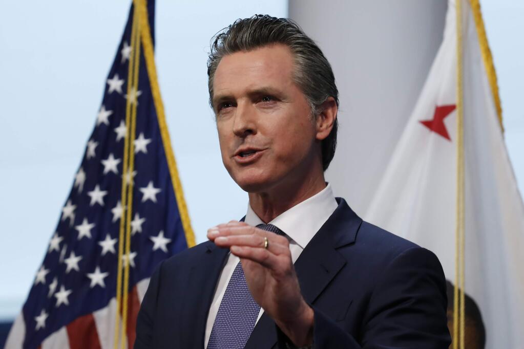 Gov. Gavin Newsom updates the state's response to the coronavirus at the Governor's Office of Emergency Services in Rancho Cordova, Calif., Monday, March 23, 2020. Newsom said he would close parking lots at dozens of beaches and state parks to prevent the spread of coronavirus after large groups flocked to the coast and mountains to get outdoors on the first weekend since the state's stay-at-home order took effect. (AP Photo/Rich Pedroncelli, Pool)