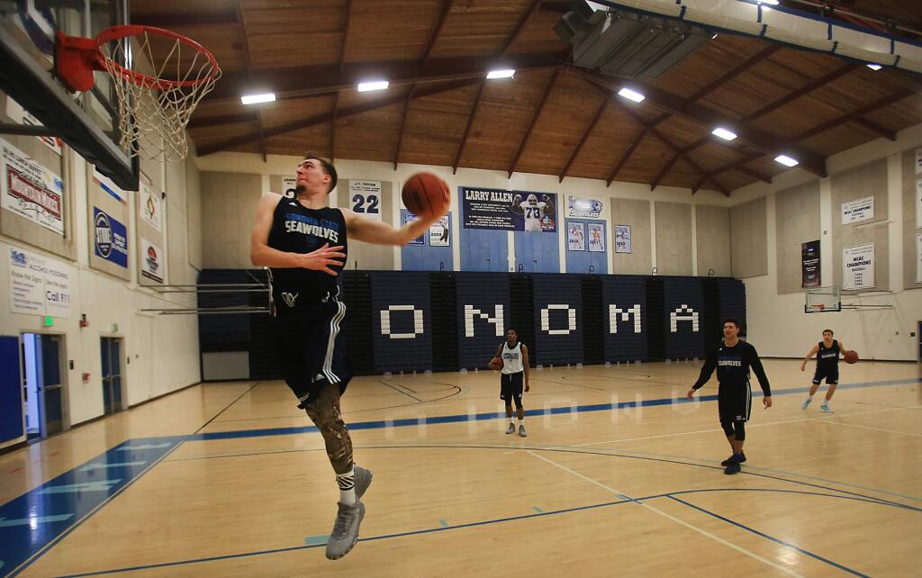 Luke Cochran on his way to a dunk at the tail end of Sonoma State University's men's basketball practice, Thursday Feb. 2, 2016 in Rohnert Park. (Kent Porter / Press Democrat)
