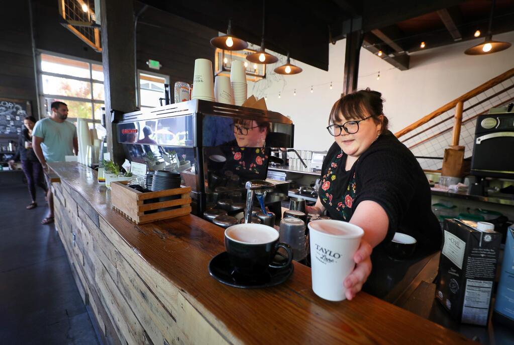 Barista Evie Holl serves up an order at Taylor Lane Organic Coffee, at The Barlow in Sebastopol on Friday, September 27, 2019. (Christopher Chung/ The Press Democrat)