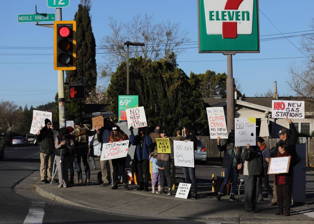 Protesters hold signs in opposition to plans to build a 7-Eleven gas station at the corner of Hwy. 12 and Middle Rincon Rd. in Santa Rosa on Monday, February 24, 2020. (BETH SCHLANKER/ The Press Democrat)