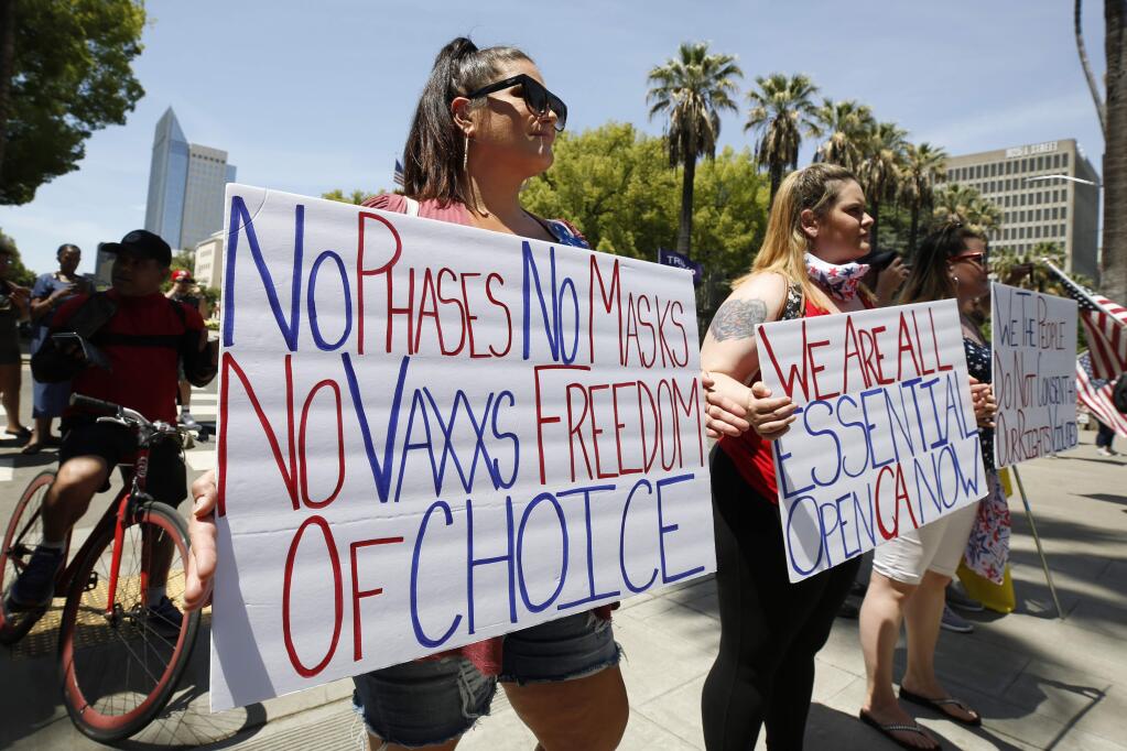 Demonstrators calling for Gov. Gavin Newsom to end the stay-at-home orders during a protest at the Capitol on Saturday. (RICH PEDRONCELL / Associated Press)