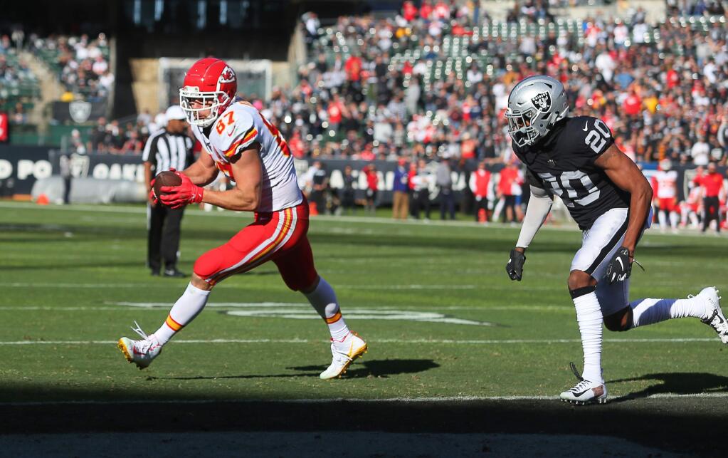 Kansas City Chiefs tight end Travis Kelce catches a pass and runs into the end zone against Oakland Raiders cornerback Daryl Worley during their game in Oakland on Sunday, December 2, 2018. (Christopher Chung/ The Press Democrat)