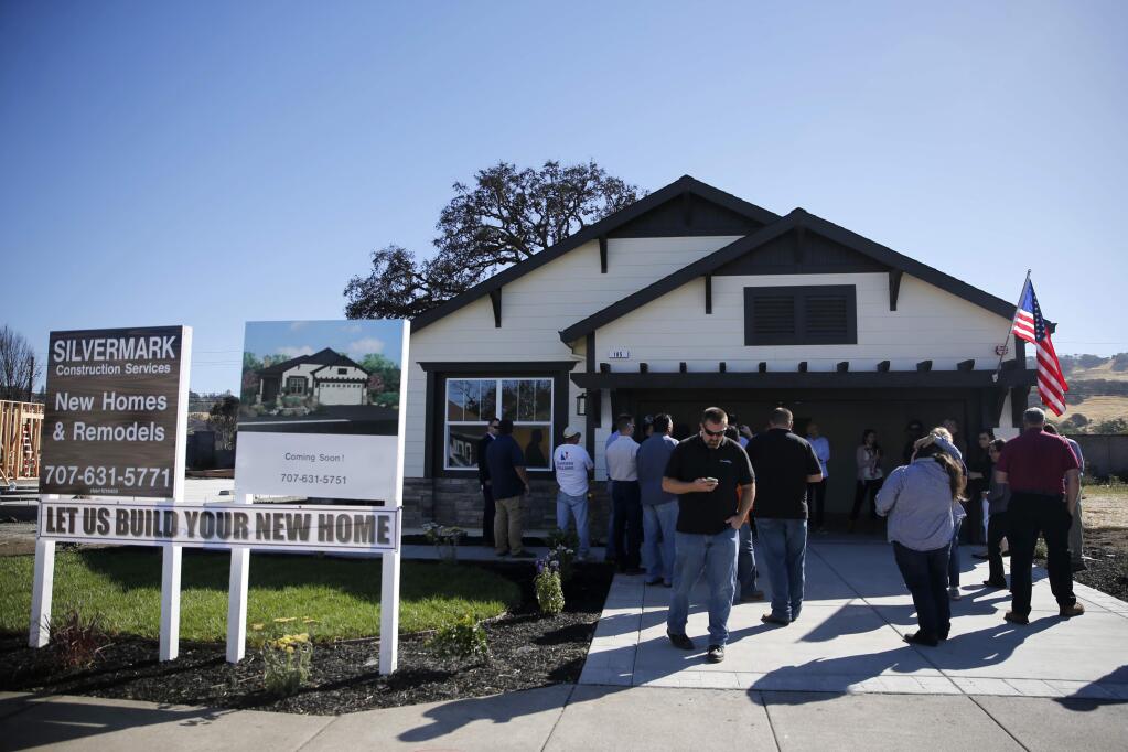 A celebratory gathering Thursday at a newly finished home on Willow Green Place in the unincorporated area of Sonoma County near Santa Rosa. (BETH SCHLANKER / The Press Democrat)