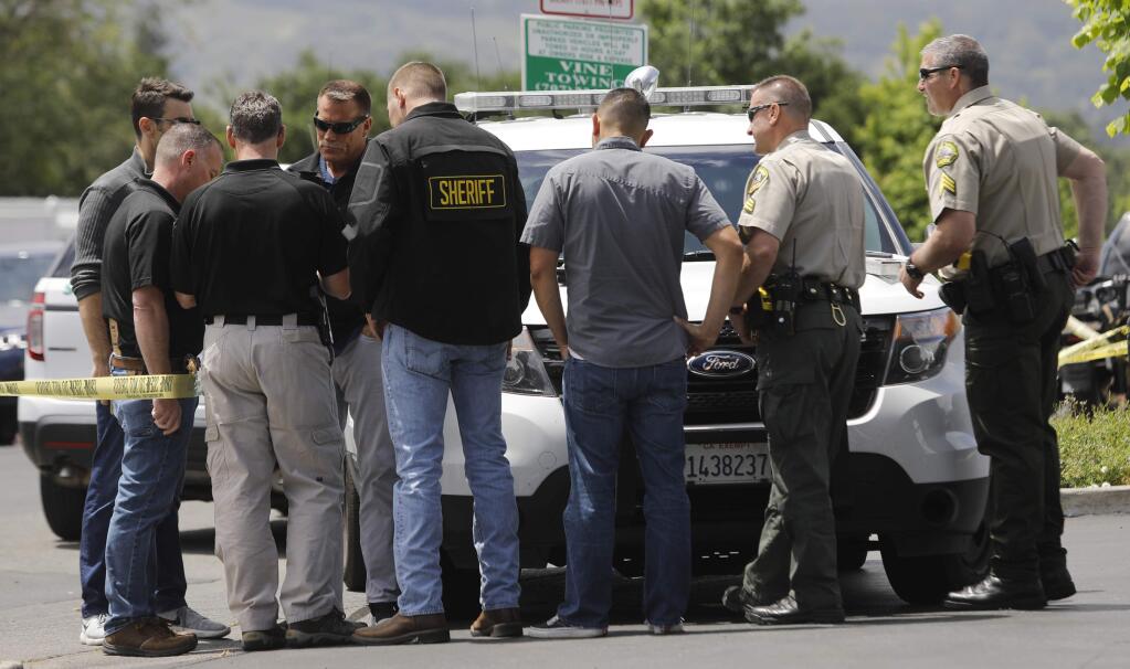Members of the Sonoma County Sheriff's Office investigate the reported shooting of a sheriff's deputy by a employee of the Jolly Washer Car Wash on Sunday, May 13, 2018 in Sonoma, California . The Mobile Support Team was not able to respond to the call. (BETH SCHLANKER/The Press Democrat)