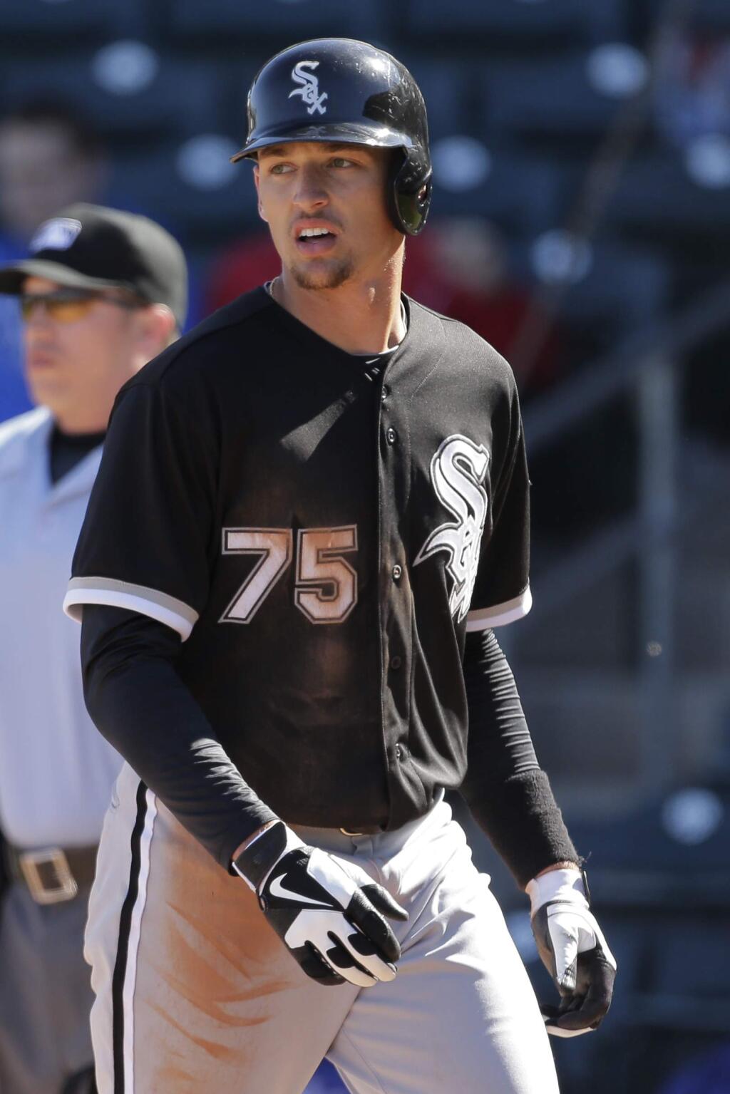 Chicago White Sox's Trayce Thompson walks back to the dugout after scoring during an exhibition spring training baseball game against the Texas Rangers Tuesday, Feb. 26, 2013, in Surprise, Ariz. (AP Photo/Charlie Riedel)
