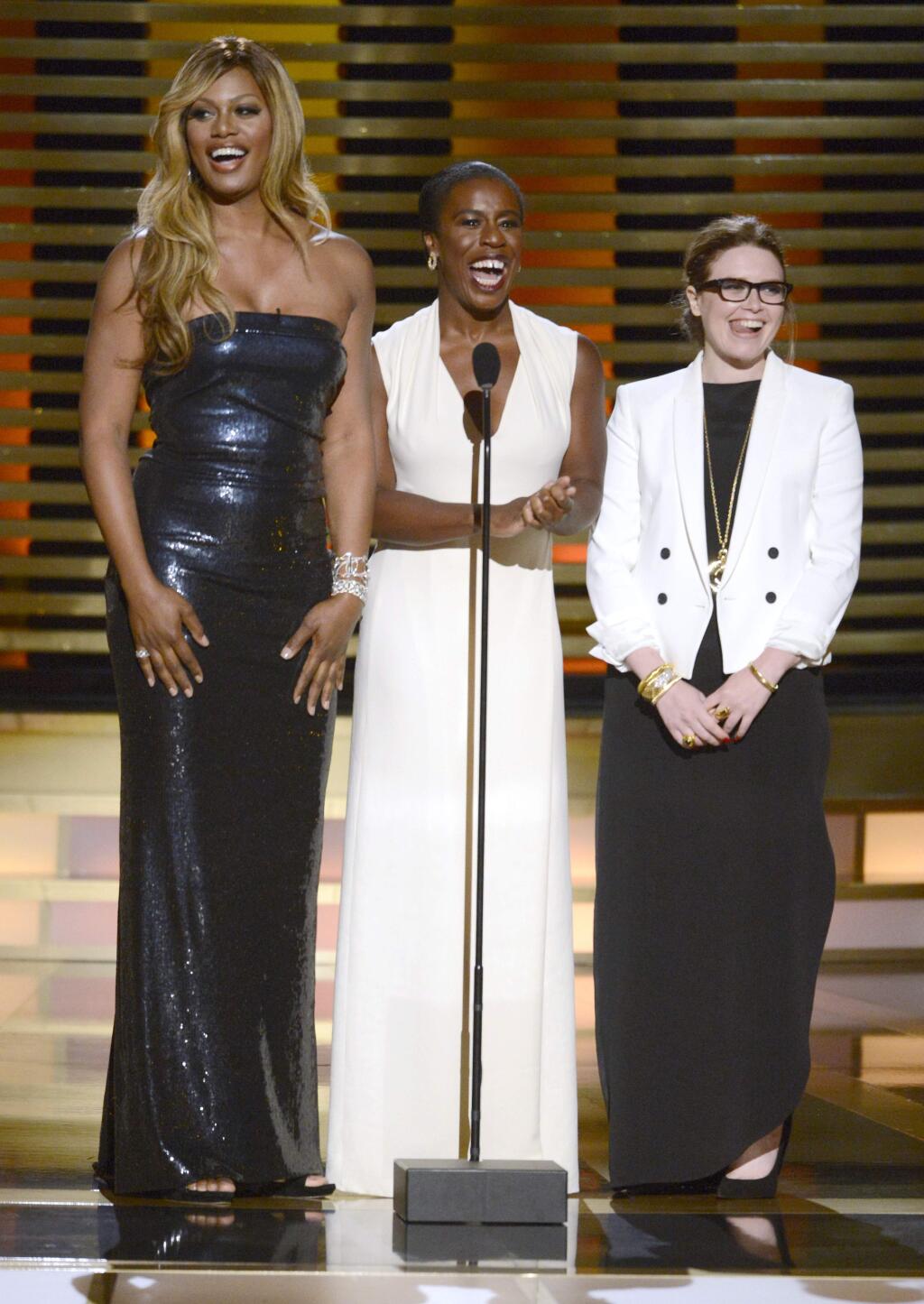 IMAGE DISTRIBUTED FOR THE TELEVISION ACADEMY - Laverne Cox, and from left, Uzo Aduba and Natasha Lyonne speak on stage at the Television Academy's Creative Arts Emmy Awards at the Nokia Theater L.A. LIVE on Saturday, Aug. 16, 2014, in Los Angeles. (Photo by Phil McCarten/Invision for the Television Academy/AP Images)