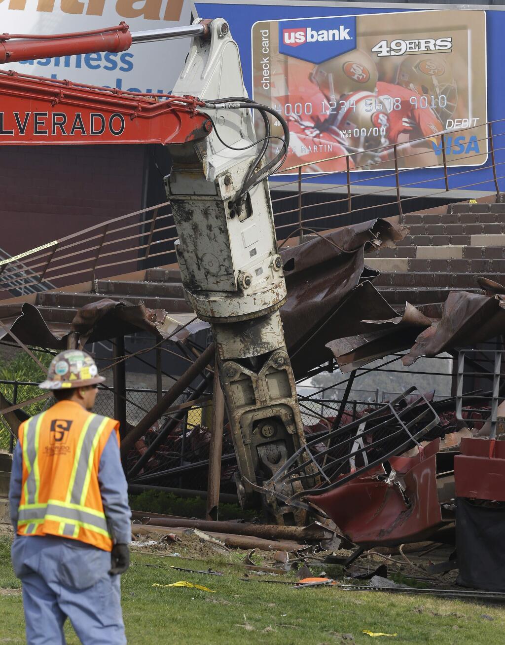 A construction worker supervises as demolition of the stands begins at Candlestick Park, Wednesday, Feb. 4, 2015, in San Francisco. (AP Photo/Ben Margot)