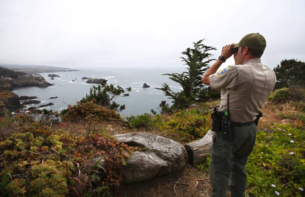 Fish and Wildlife warden Don Powers looks for abalone divers along the Mendocino coast, near Little River on Friday, May 22, 2015. (Christopher Chung/ The Press Democrat) Sonoma Magazine