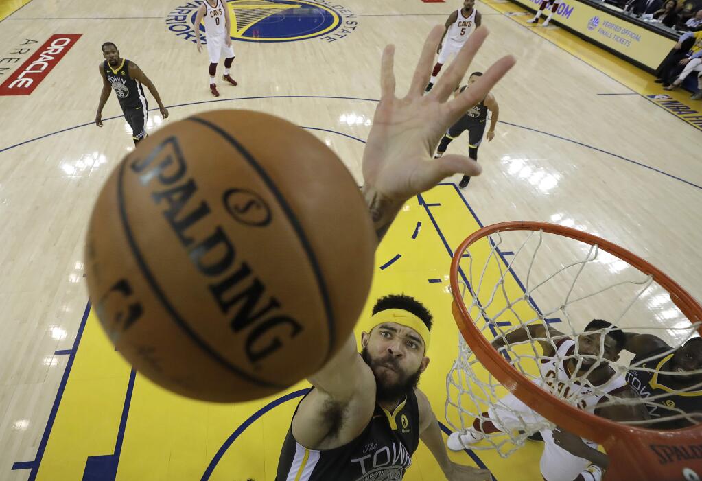 Golden State Warriors center JaVale McGee reaches for a rebound during the first half of Game 2 of the NBA Finals between the Warriors and the Cleveland Cavaliers in Oakland, Sunday, June 3, 2018. (AP Photo/Marcio Jose Sanchez, Pool)