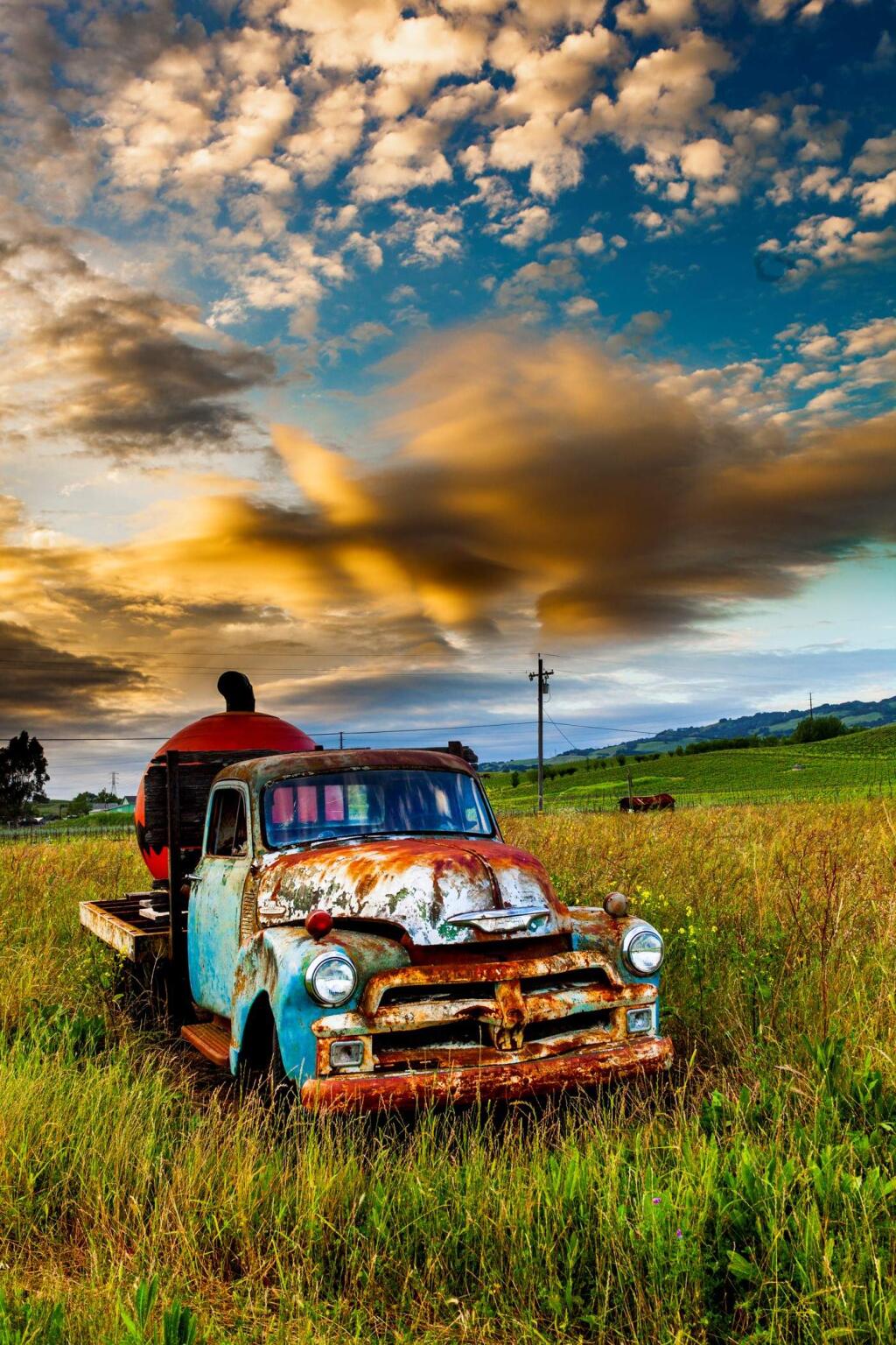 The odd juxtaposition of this achingly gorgeous sunset (a winter dusk blossoming across the sky with fiery, cottony clouds hanging over the hills and fields of Petaluma) and the old colorfully weathered truck (with its enormous metal jack-o-lantern in the bed, familiar to many who drive the back roads between Petaluma and Sonoma), is a potent reminder that nature claims everything, eventually. And that decay, when properly lit, can be beauftiful.'The photo happened to be taken just after sunset, while I was driving in from Sonoma,' says Bob Tradewell, describing the shot he took in early April. 'That truck's been there a long time. However, I hadn't seen that particular condition before, with the particular way the sun was coming up behind it.'Asked what he finds most appealing about this little part of the world, Tradewell answers the question through the lens of a decidedly humane perspective. 'The beauty of Petaluma,' he says, 'is first the people and the small town atmosphere of pulling together. The area's visual beauty is a given. It's a positive attitude that brings it into the light.'(PHOTO BY BOB TRADEWELL)