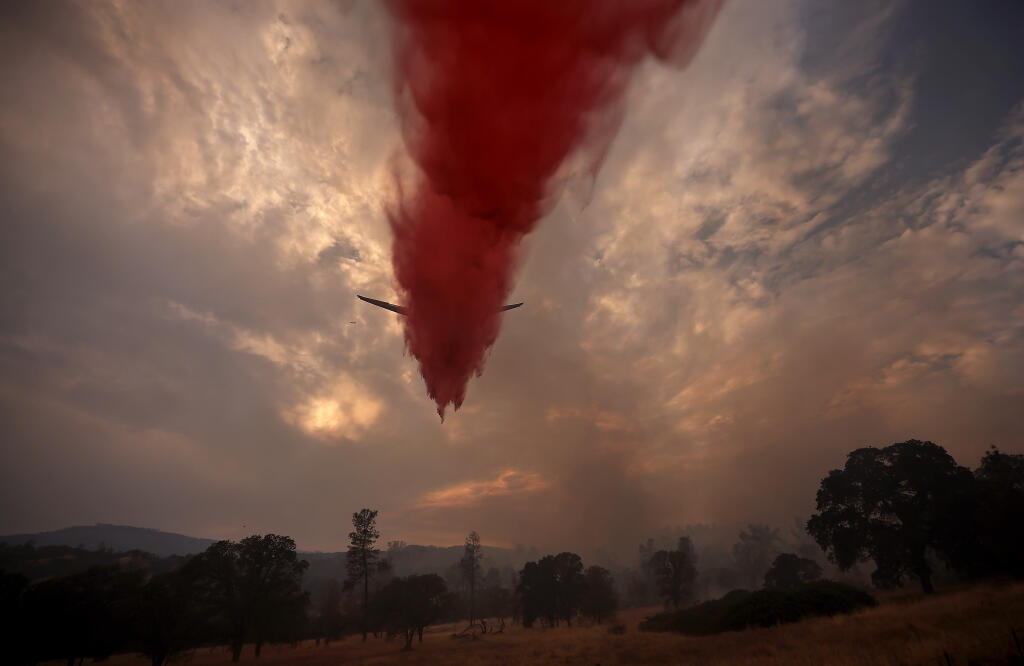 An MD-87 Erickson Aero Tanker is used to make a drop on the Coyote fire at Hidden Valley Lake, Friday, Aug 13, 2021, that burned 100 acres and threatened several homes. (Kent Porter / The Press Democrat) 2021