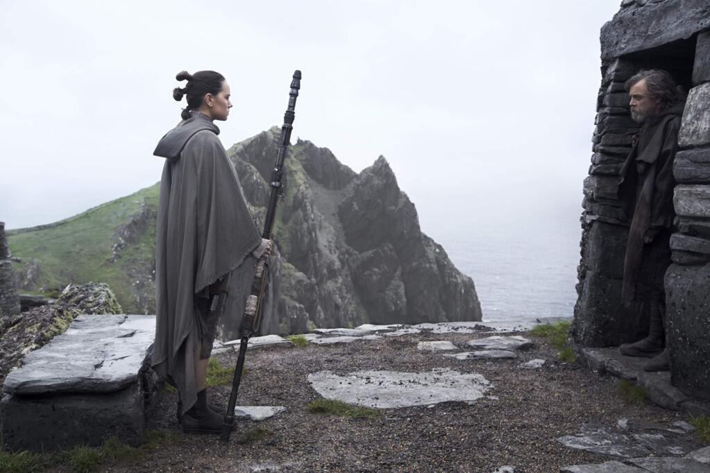 Courageous orphan Rey (Daisy Ridley) has finally tracked down Luke Skywalker (Mark Hamill) after vanquishing the maybe-evil, maybe-just-mixed-up Kylo Ren (Adam Driver) in a lightsaber duel in 'Star Wars: The Last Jedi.' (Walt Disney Films)