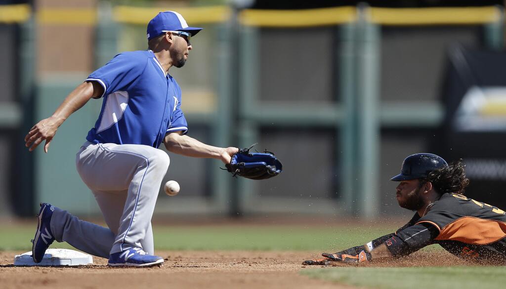 San Francisco Giants' Brandon Crawford, right, steals second base as Kansas City Royals' Omar Infante misses the ball in the second inning of a spring training exhibition baseball game Monday, March 23, 2015, in Scottsdale, Ariz. (AP Photo/Ben Margot)
