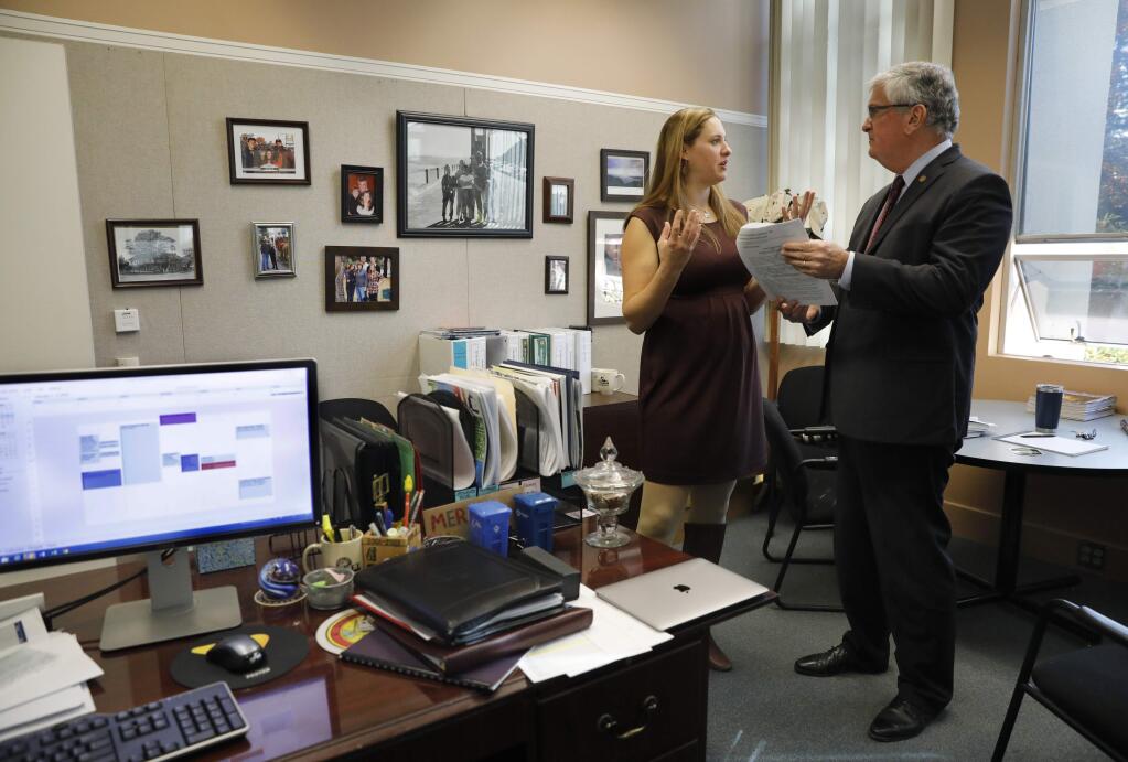 Sonoma County Supervisor David Rabbitt talks with Kay Lowtrip, the Chief Deputy Clerk of the Board of Supervisors, about the agenda for the next Board of Supervisors meeting, in his office at the County Administrator's Office Thursday, January 3, 2019 in Santa Rosa, California . (BETH SCHLANKER/The Press Democrat)