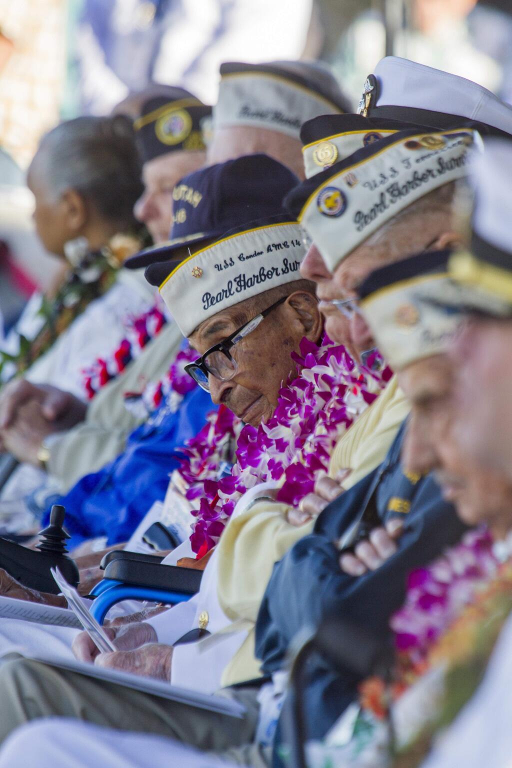 Raymond Chavez, center, the oldest living Pearl Harbor survivor is shown at 76th Anniversary Commemoration, of the Pearl Harbor attack, Thursday, Dec. 7, 2017, in Honolulu, Hawaii. Survivors gathered Thursday at the site of the Japanese attack on Pearl Harbor to remember fellow servicemen killed in the early morning raid 76 years ago, paying homage to the thousands who died with a solemn ceremony marking the surprise bombing raid that plunged the U.S. into World War II. (Dennis Oda /The Star-Advertiser via AP, Pool)
