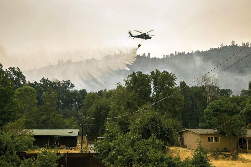 Helicopters attack a hot spot on New Long Valley Road during the Ranch Fire, Monday, Aug. 6, 2018, in Lake County, Calif. (Paul Kitagaki Jr./The Sacramento Bee via AP)