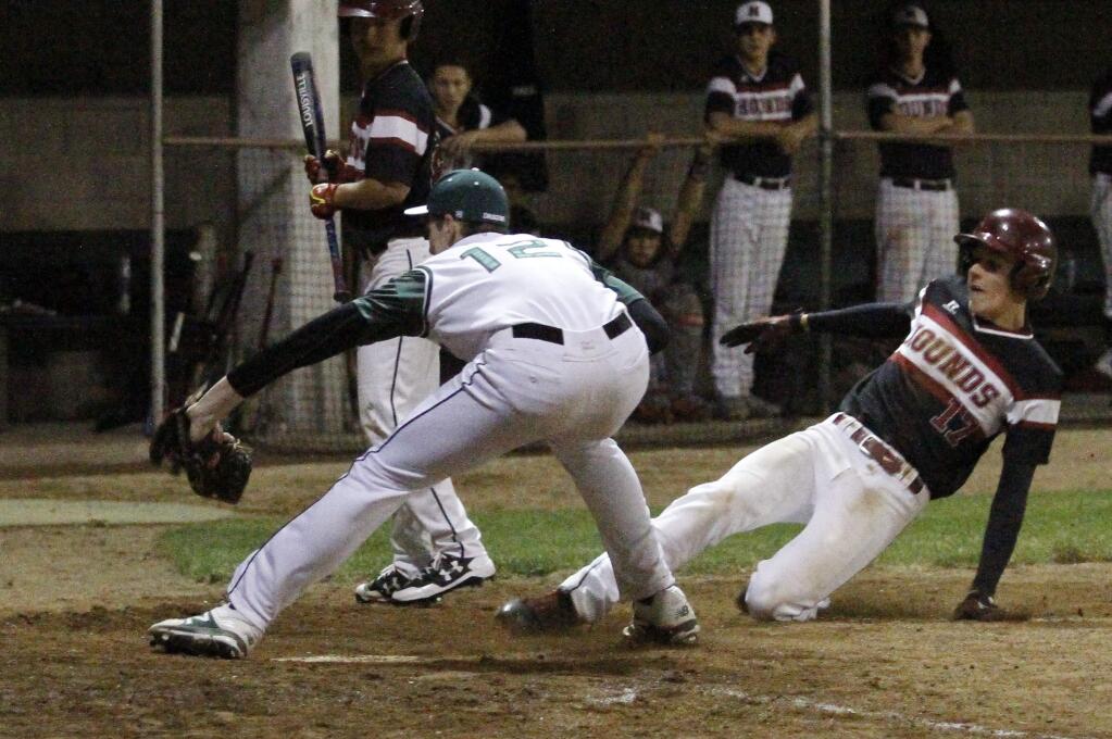 Bill Hoban/Index-TribuneSonoma's Brendon Hogan reaches for a throw during a play at the plate in Friday night's game against Healdsburg. The Dragons scored 13 runs in the first inning and coasted home to a 14-1.