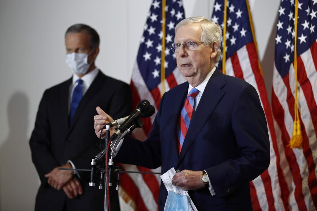 Senate Majority Leader Mitch McConnell of Ky., speaks at a news conference on Capitol Hill in Washington, Tuesday, May 12, 2020. Standing behind McConnell is Senate Majority Whip John Thune, R-S.D. (AP Photo/Patrick Semansky)