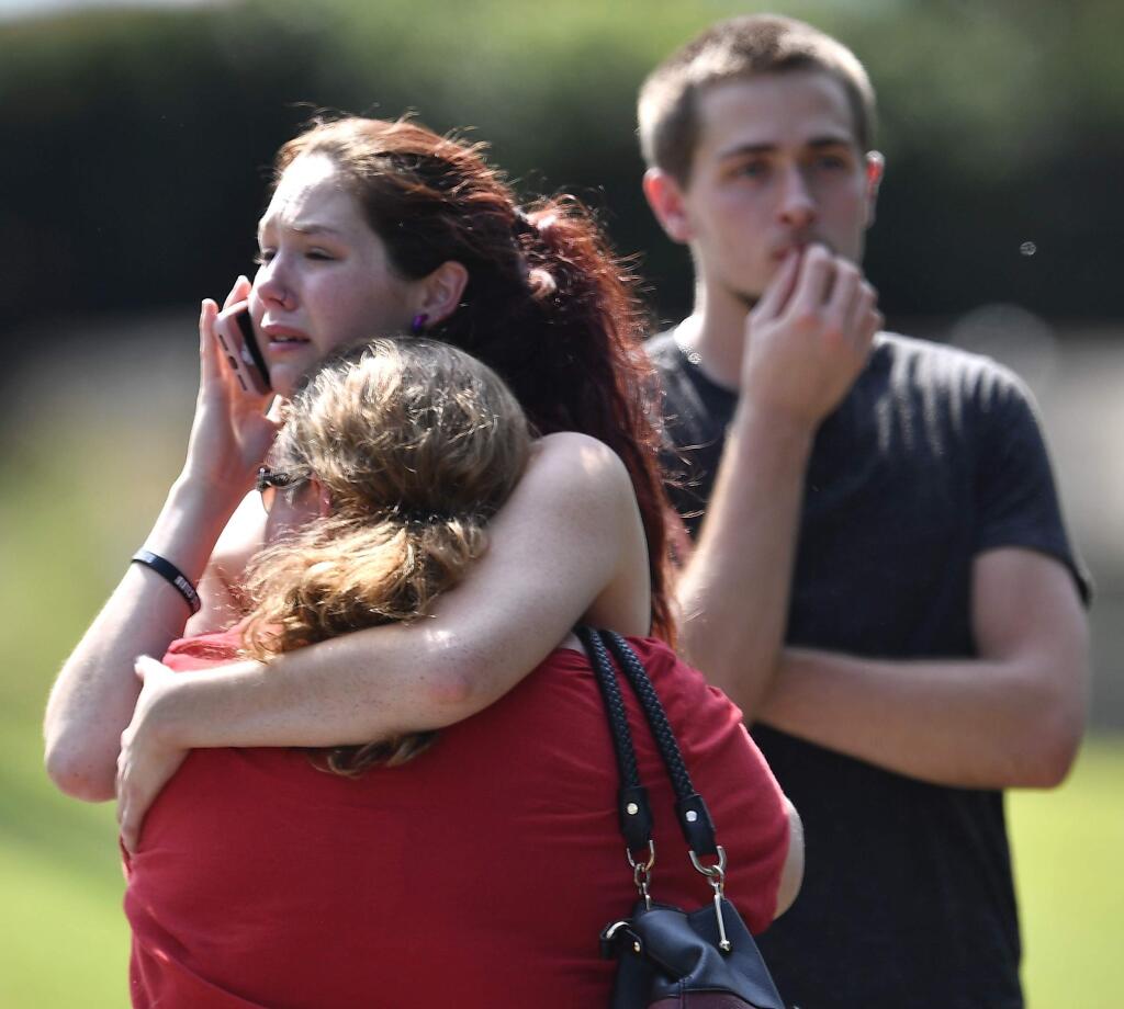 Kaitlyn Adams, a member of the Burnette Chapel Church of Christ, hugs another church member at the scene after shots were fired at the church on Sunday, Sept. 24, 2017, in Antioch, Tenn. (Andrew Nelles/The Tennessean via AP)