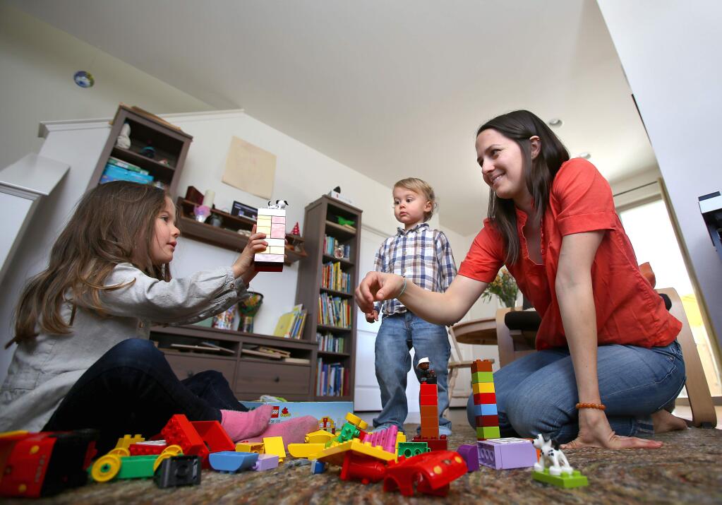 Samantha Jacques, right, plays with her children, Mateo, 2, and Soleil, 4, in their Sonata subdivision home, in Healdsburg on Friday, February 27, 2015. (Christopher Chung/ The Press Democrat)