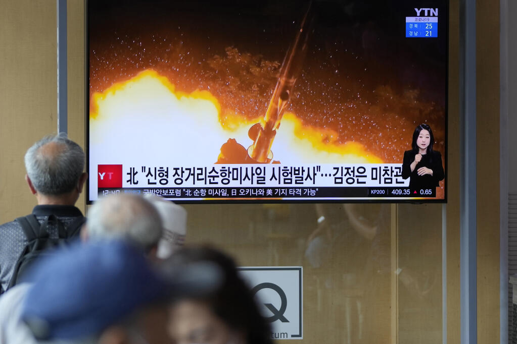 People watch a news program that was showing part of a North Korean handout photo that says, "North Korea's long-range cruise missiles tests," in Seoul, South Korea, Monday, Sept. 13, 2021. North Korea says it successfully test-fired newly developed long-range cruise missiles over the weekend, its first known testing activity in months, underscoring how it continues to expand its military capabilities amid a stalemate in nuclear negotiations with the United States. The letters read, "The North test-fired newly developed long-range cruise missiles." (AP Photo/Lee Jin-man)