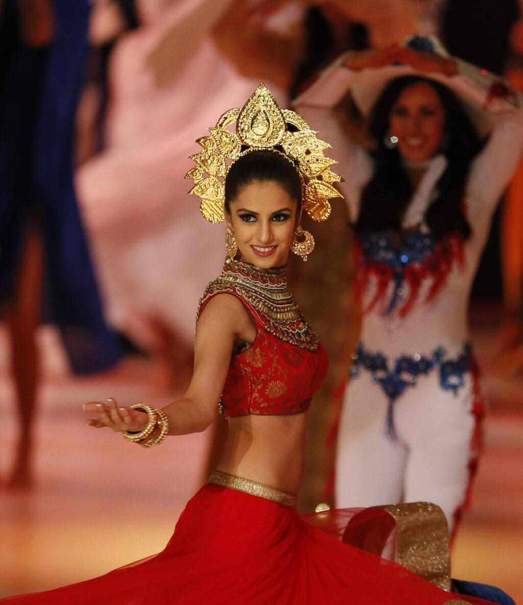 Miss India Koyal Rana dances on stage during a segment of the Miss World competition, at the ExCel centre, in London, Sunday, Dec. 14, 2014. (AP Photo/Alastair Grant)