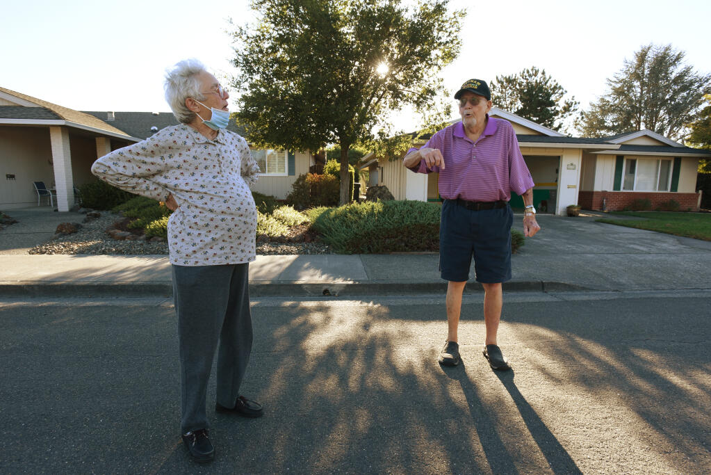 Sue Hattendorf, left, chatting with her neighbor Bill Grace after the two arrived back home after mandatory evacuation orders were lifted in Oakmont Village of Santa Rosa, Calif. on Sunday, October 4, 2020. Hattendorf spent most of the week at the Santa Rosa Veterans Memorial Hall while Grace slept at a friendÕs home in Santa Rosa.(Photo: Erik Castro/for The Press Democrat)