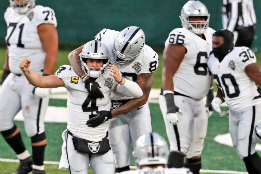 Las Vegas Raiders quarterback Derek Carr (4) celebrate after throwing a touchdown pass to Henry Ruggs III during the second half an NFL football game against the New York Jets, Sunday, Dec. 6, 2020, in East Rutherford, N.J. (AP Photo/Noah K. Murray)