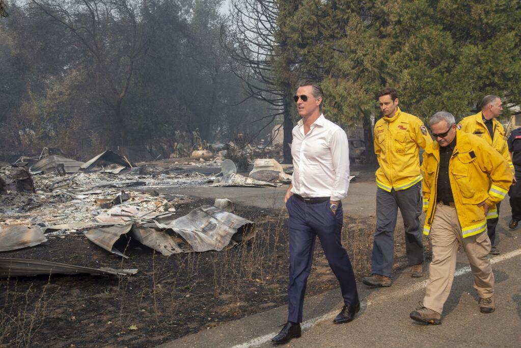 Gov. Gavin Newsom passes a burned home in Geyserville during a Friday tour of damage caused by the Kincade fire. (KARL MONDON / San Jose Mercury News)