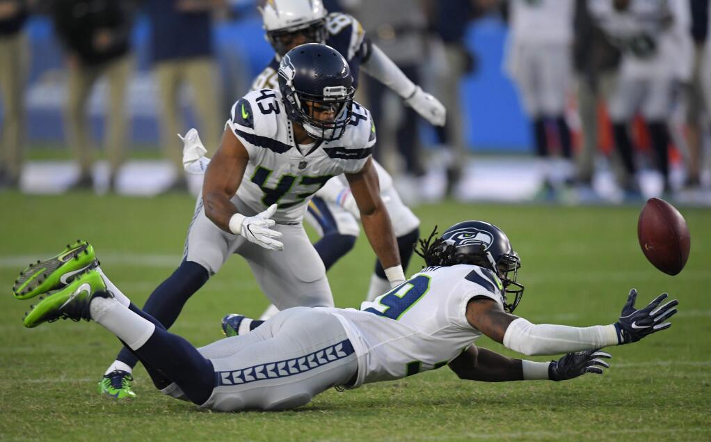Seattle Seahawks safety Demetrius McCray just misses a chance at an interception during the second half against the Los Angeles Chargers on Sunday, Aug. 13, 2017, in Carson. (AP Photo/Mark J. Terrill)