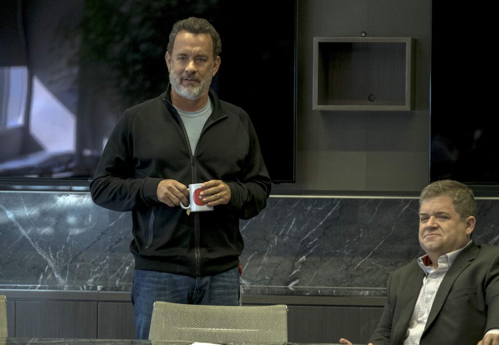This image released by STX Entertainment shows Tom Hanks, left, and Patton Oswalt in a scene from 'The Circle.' (Frank Masi/ STX Financing via AP)