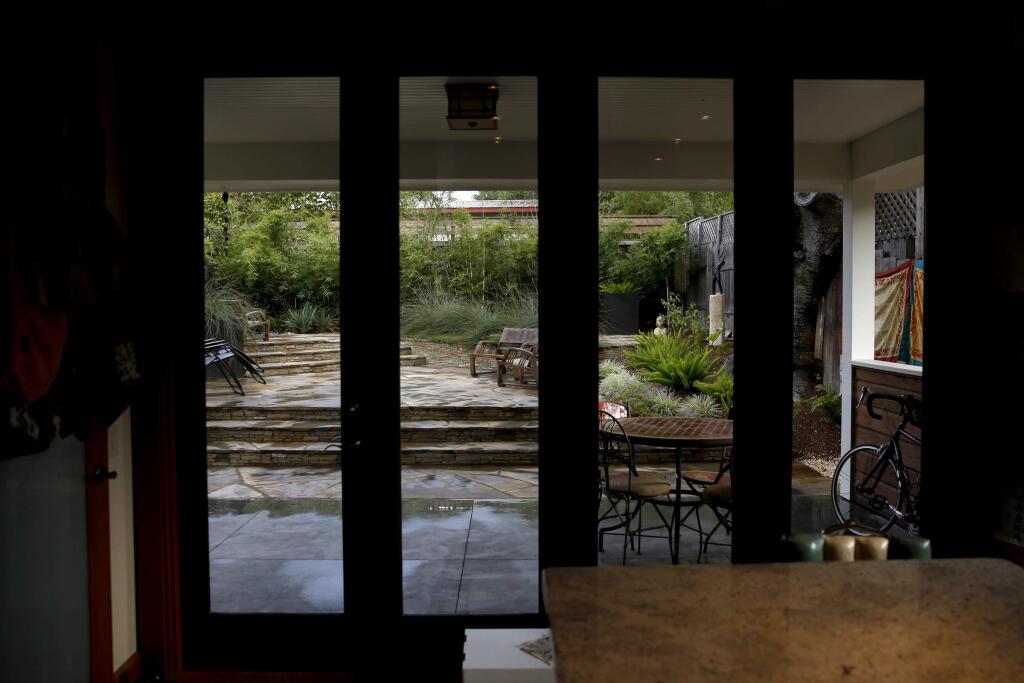 The backyard can be seen through glass doors in Lisa Clyde's kitchen in Sebastopol, California on Thursday, August 14, 2014. BETH SCHLANKER/ The Press Democrat)