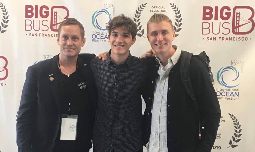 El Molino High School sophomore Kaden Anderson, center, on March 10 at the San Francisco International Ocean Film Festival. Anderson won first place in the festival's student film competition for high school students, and he is standing next to event emcee Brett Loveman, left, and Swedish filmmaker Joaquin Odelberg. (Julie Frye)