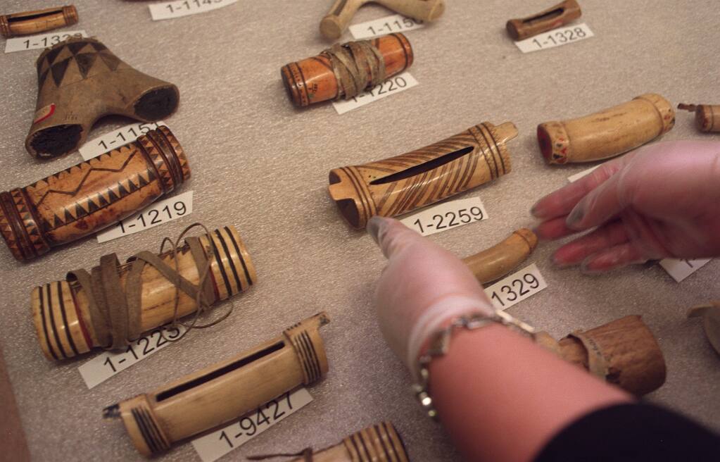 A Yurok tribe member inventories artifacts at the Hearst Anthropology Museum at UC Berkeley in 1999. (San Jose Mercury News)