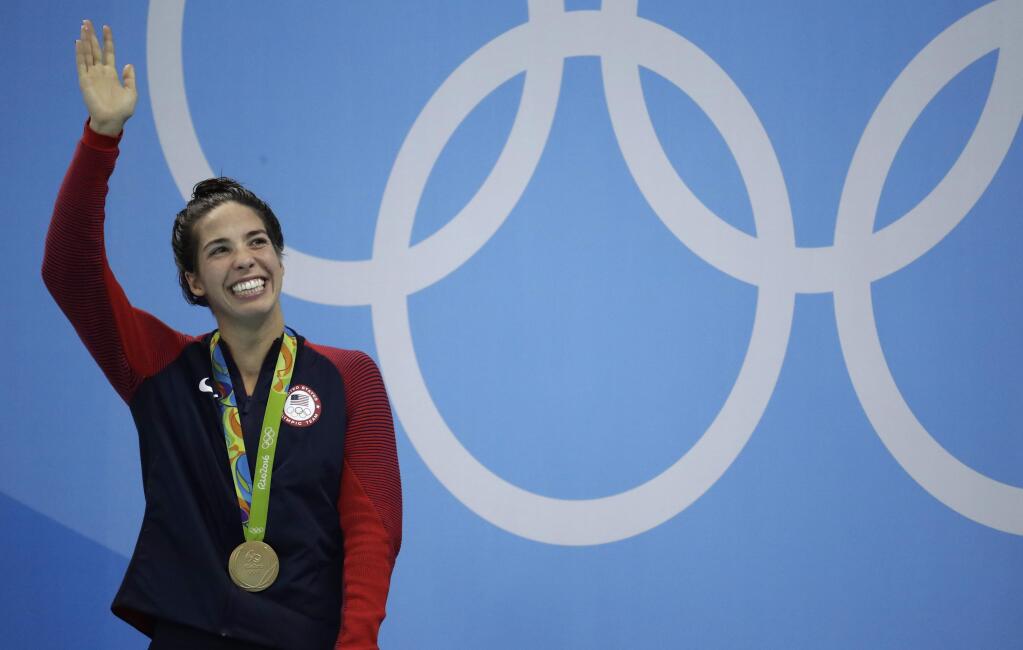 United States' Maya DiRado celebrates with her gold medal during the women's 200-meter backstroke medals ceremony during the swimming competitions at the 2016 Summer Olympics, Friday, Aug. 12, 2016, in Rio de Janeiro, Brazil. (AP Photo/Dmitri Lovetsky)