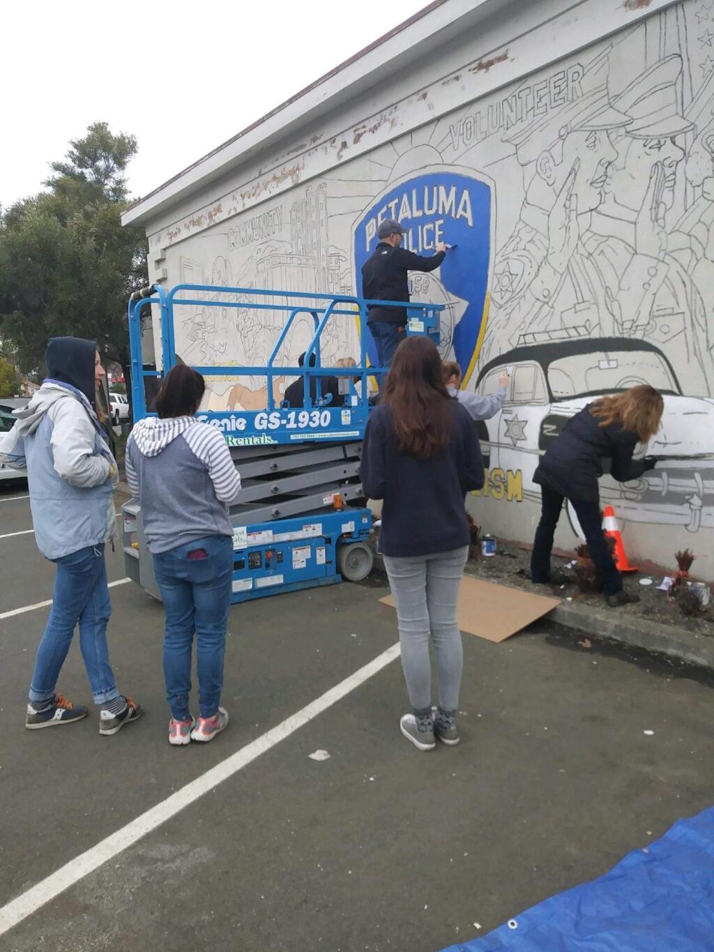 JOHN JACKSON/ARGUS-COURIER STAFFSt. Vincent High School students paint a mural on the back of the Petaluma Police station, just one of many projects they undertook on their Day of Service.