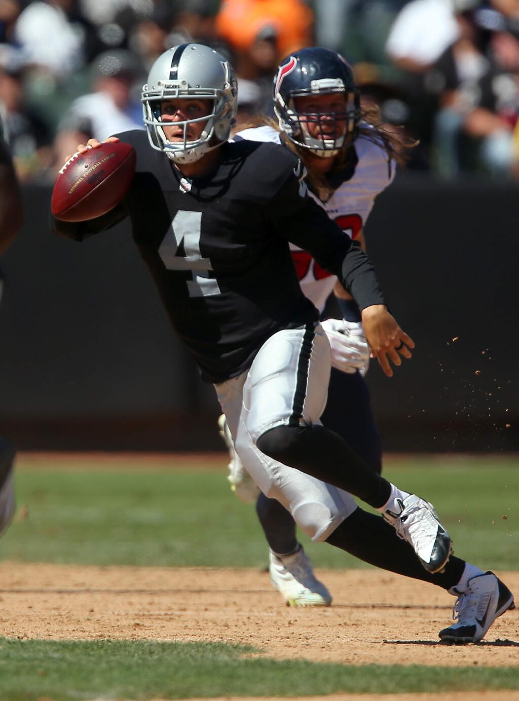 Oakland Raiders quarterback Derek Carr scrambles against the Houston Texans during their game in Oakland on Sunday, September 14, 2014. The Texans defeated the Raiders 30-14.(Christopher Chung/ The Press Democrat)