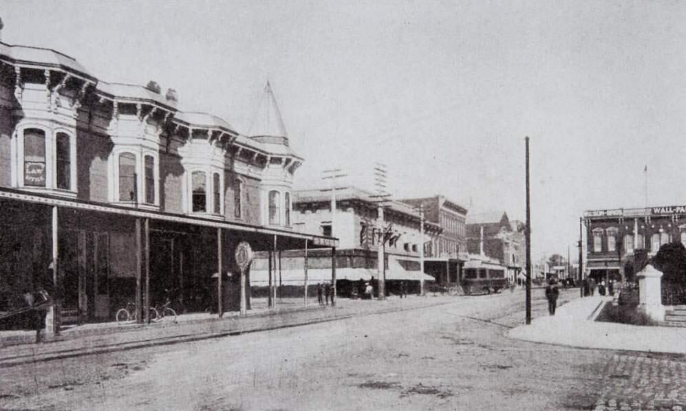 A view looking east from Exchange Avenue down Fourth Street showing the courthouse grounds to the right; a drug store to the left; a trolley, center; and The Wilson Bros. paint shop to the right at 222 Hinton Ave., early 1900s. (Courtesy of the Sonoma County Library)