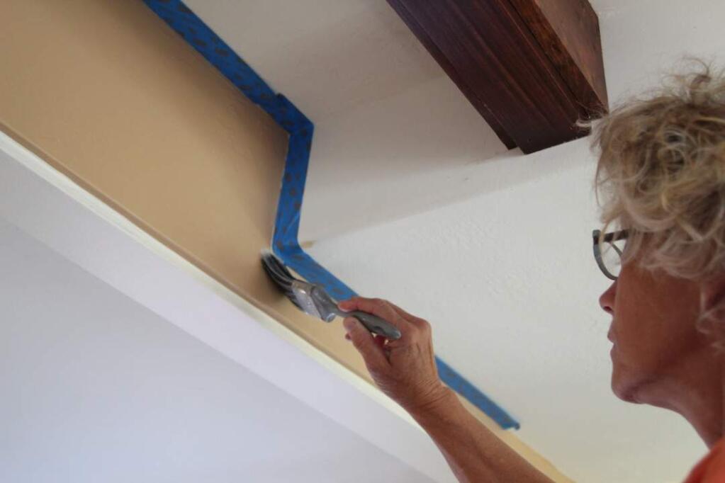Use painter's tape to achieve a crisp edge between wall and ceiling. If the tape for your project will remain in place for a few days, use blue painter's tape because it doesn't permanently bond to painted surfaces.