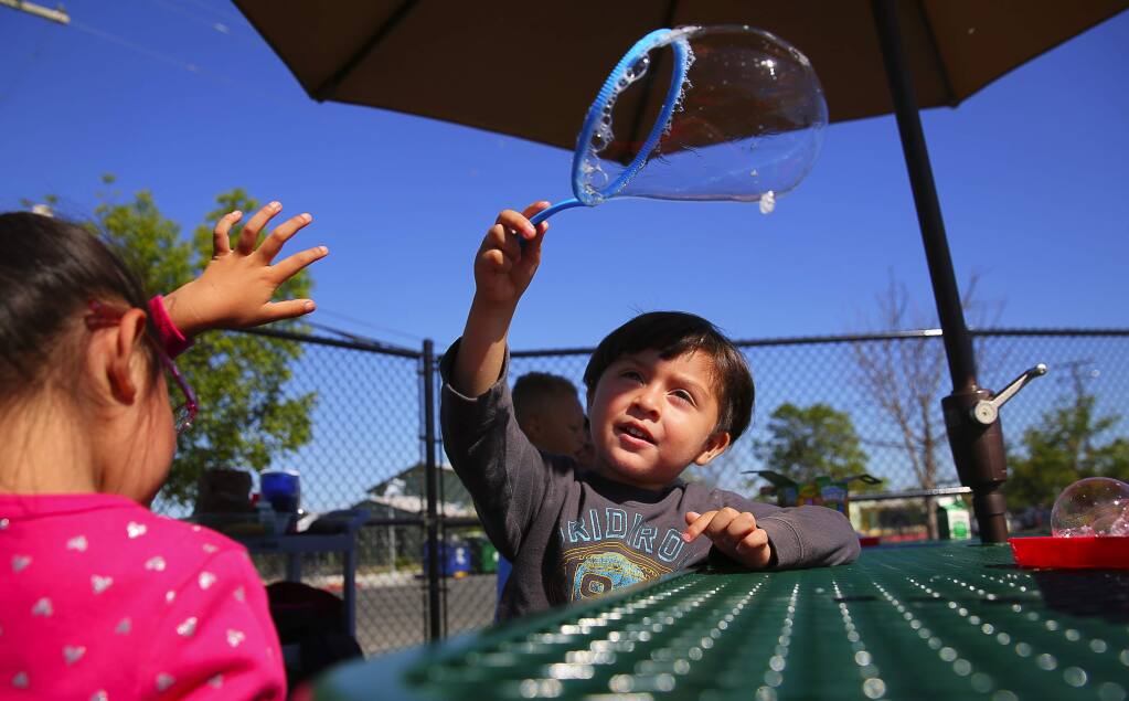 Dominic Ceja Morena, 3, makes bubbles on the playground during a Pre-K special day class at the Bellevue School District Early Learning Center, in Santa Rosa on Wednesday, June 14, 2017. (Christopher Chung/ The Press Democrat)