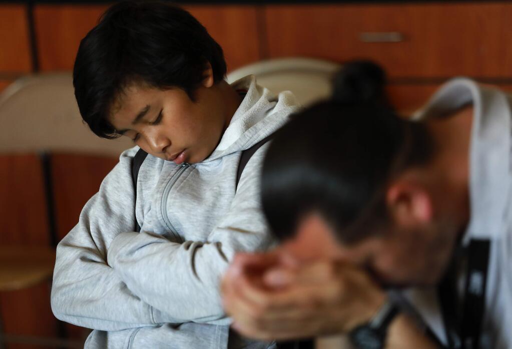 Eighth grader Justin Chhum, 13, closes his eyes during the 15 minutes of 'Quiet Time' at Cook Middle School in Santa Rosa. The meditative practice has led to increases in GPA and decreases in suspensions. (John Burgess/The Press Democrat)