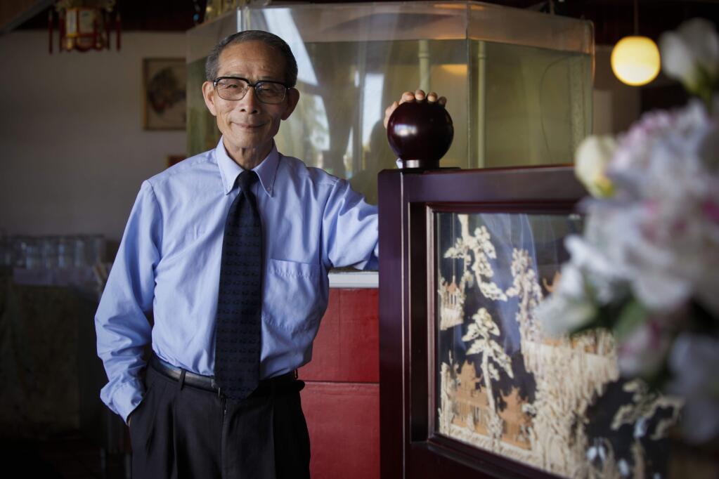 Petaluma, CA, USA. Tuesday, August 01, 2016._ Bailian Zheng, 68, sits in his restaurant, Kwei Bai (which means 'honorable guest' in Chinese). Zheng earned his Master's degree in English at Sonoma State and works at the downtown Petaluma Post Office. (CRISSY PASCUAL/ARGUS-COURIER STAFF)