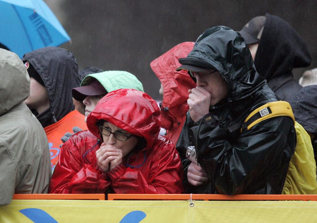 Spectators try to stay warm in the pouring rain while watching the first stage of the Tour of California in downtown Santa Rosa in 2009. (PD FILE)