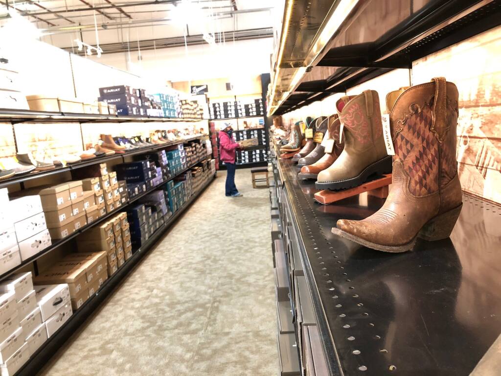 Lizzy Badajos shops for boots at Wilco, a new store that opened in Petaluma on Dec. 1, 2020. MATT BROWN/ARGUS-COURIER STAFF