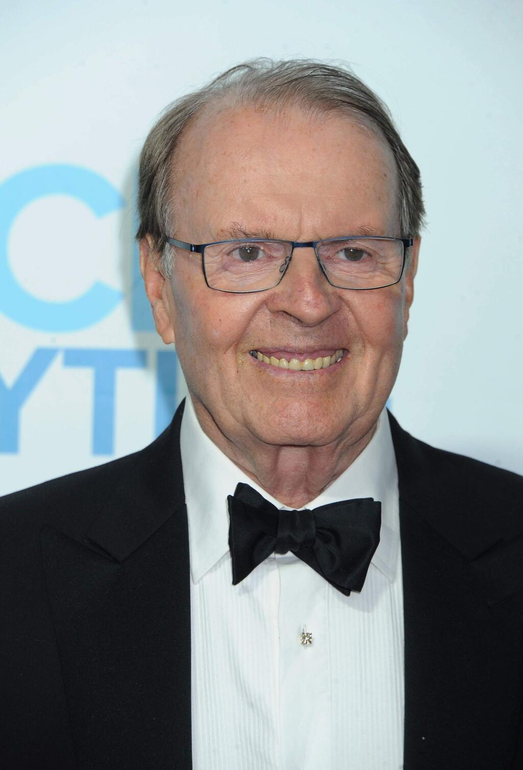 FILE - In this June 22, 2014, file photo, Charles Osgood arrives at the Daytime Emmy Awards Afterparty at The Beverly Hilton in Beverly Hills, Calif. Osgood, who has said 'good morning' to his audience every Sunday, will say 'goodbye' as host of 'CBS News Sunday Morning.' He announced his Sept. 25, 2016, departure on the Sunday, Aug. 28, 2016, edition. (Photo by Katy Winn/Invision/AP, File)
